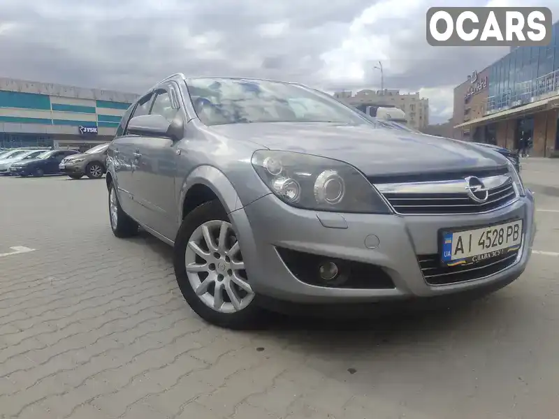 Універсал Opel Astra 2009 1.6 л. Ручна / Механіка обл. Київська, Вишневе - Фото 1/21